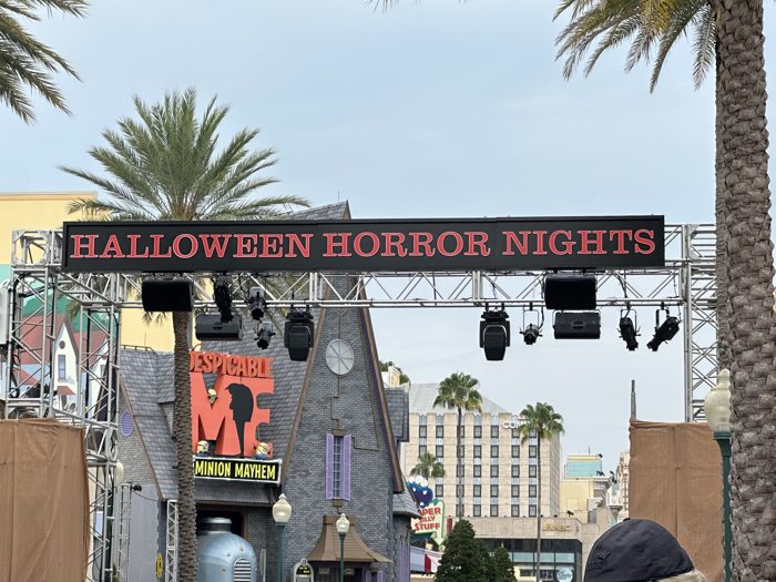 The Halloween Horror Nights marquee glows above the palm-lined walkway at Universal Studios.