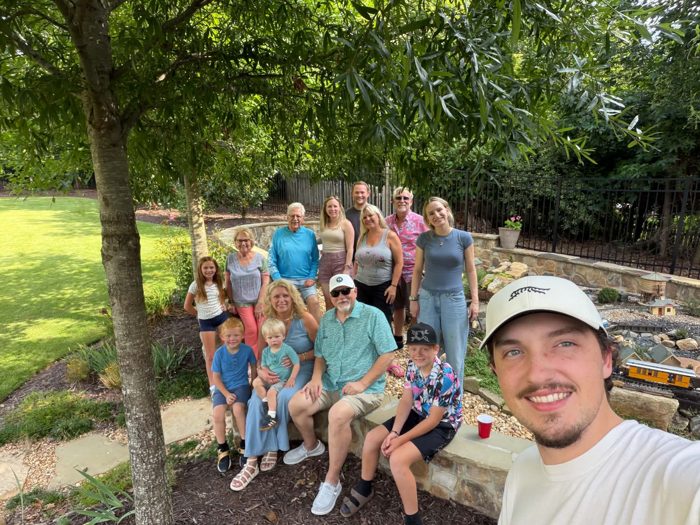A wide-angle selfie catches the whole family crew, from the grandparents down to the littlest ones.