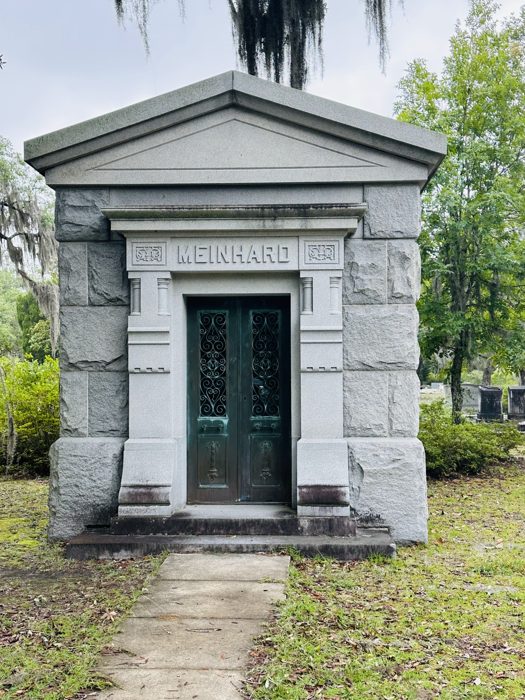 A classic stone mausoleum framed by oaks at Bonaventure Cemetery.