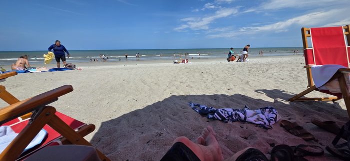 Feet up and relaxed as the family settles into an easy beach afternoon.