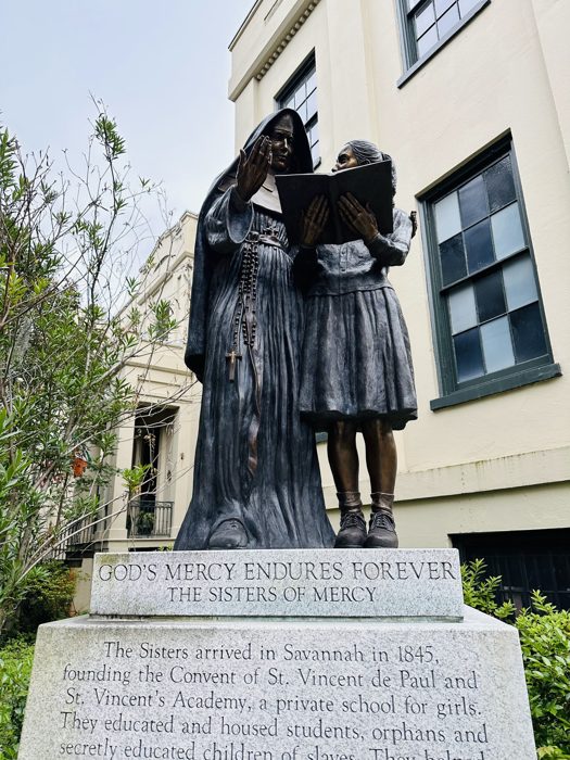 Pausing to read the story behind a bronze statue tucked along a Savannah street.