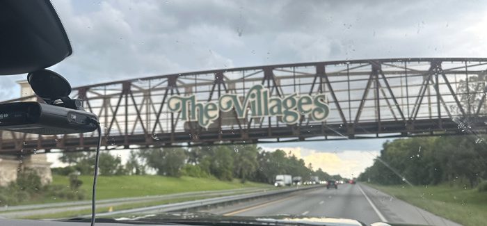 Rolling through The Villages, catching the town's iconic archway sign from the road.