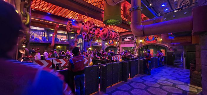 Winding through the glowing pipes and gears of the Mario Kart queue.