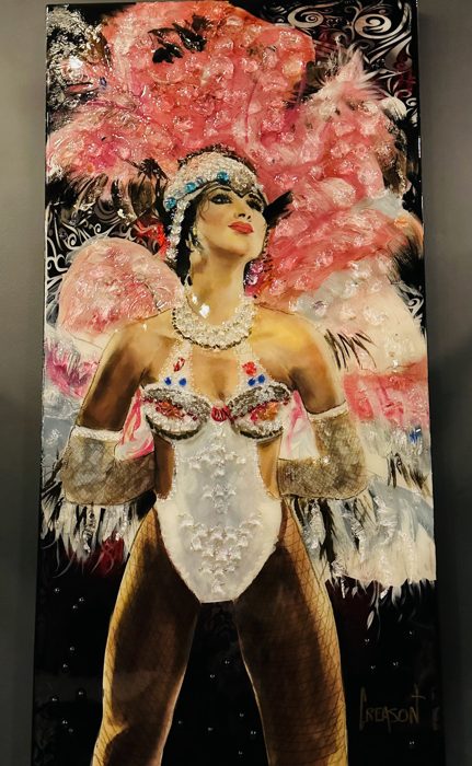 Dazzling feathered showgirl costumes on display at a Mardi Gras exhibit.