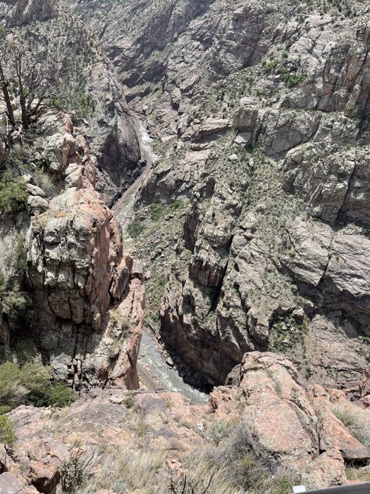 The rugged granite cliffs of the Royal Gorge towering up from the canyon floor.
