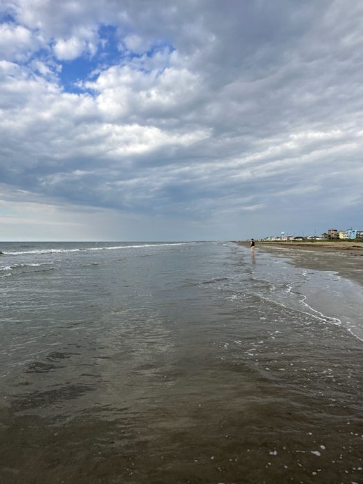 Calm tide rolling in along the empty Gulf-coast shoreline.