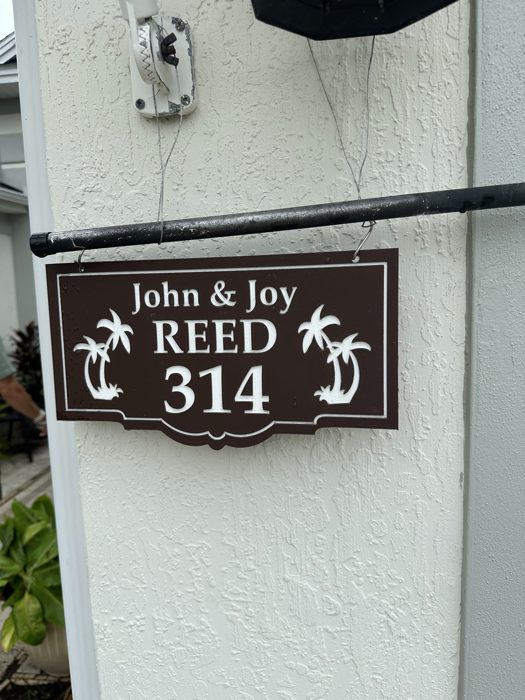 A cheerful palm-tree address plaque hangs by the door where we're staying.