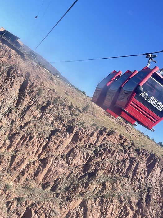 Riding the bright red aerial gondola high over the gorge.
