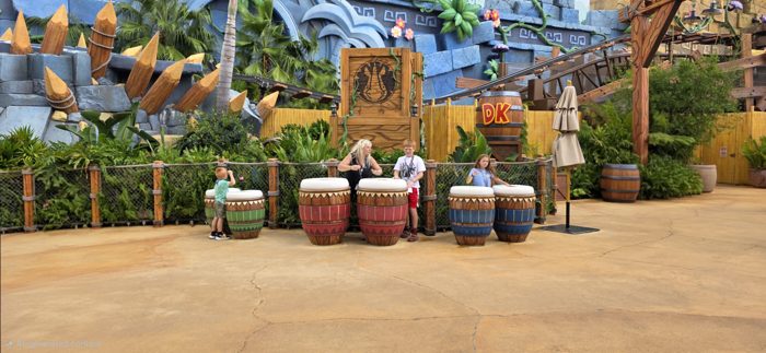 The kids take turns pounding the giant jungle drums at the Donkey Kong photo spot.