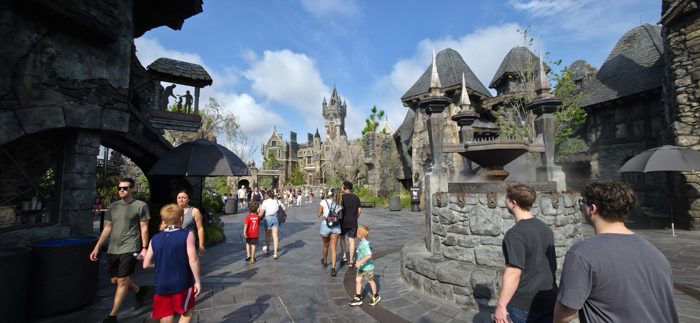 Weaving through the misty stone streets of the monster-movie land, castle spires overhead.