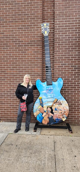 Posing with one of Beale Street's giant painted guitar sculptures.