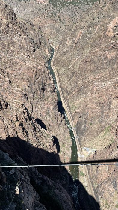 Peering straight down through the bridge to the Arkansas River far below.