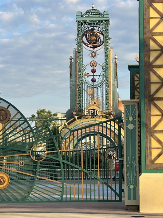 A closer look at the intricate astronomical clockwork crowning the Epic Universe entrance gate.