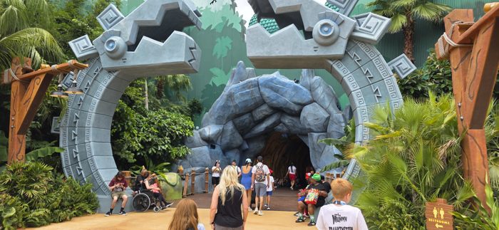 Passing beneath the stone serpent archway into the jungle-themed land.