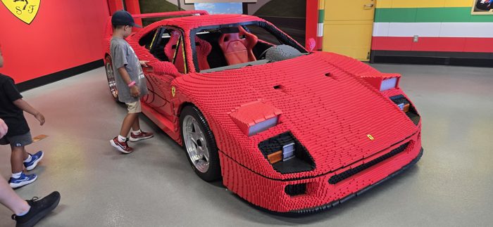 A gleaming red Ferrari on display in the park's car exhibit.