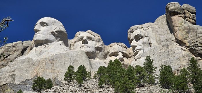 The four presidents of Mount Rushmore framed by the rocky overlook.