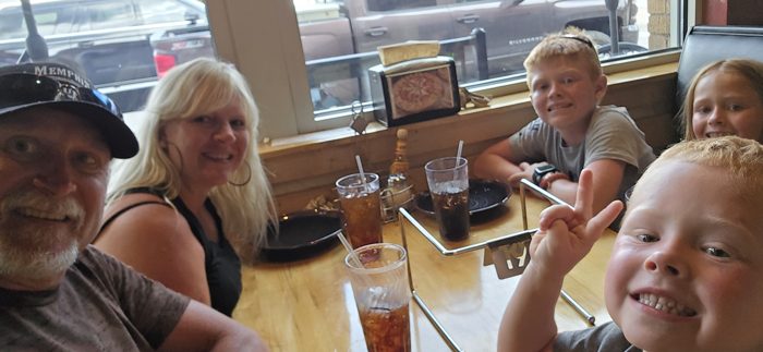 Family gathered around the table for a relaxed lunch out in town.