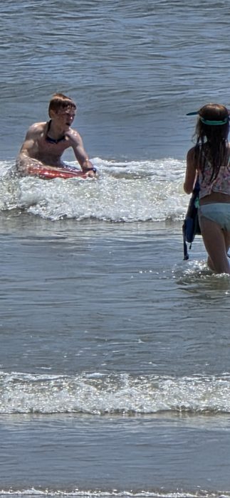 Riding a wave in while the rest of the group wades out.