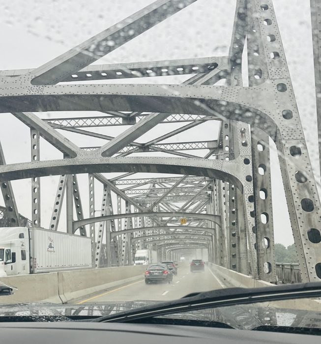 Crossing the steel truss bridge over the Mississippi River in the rain.