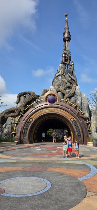 Making our way across the mosaic plaza toward the towering archway entrance.