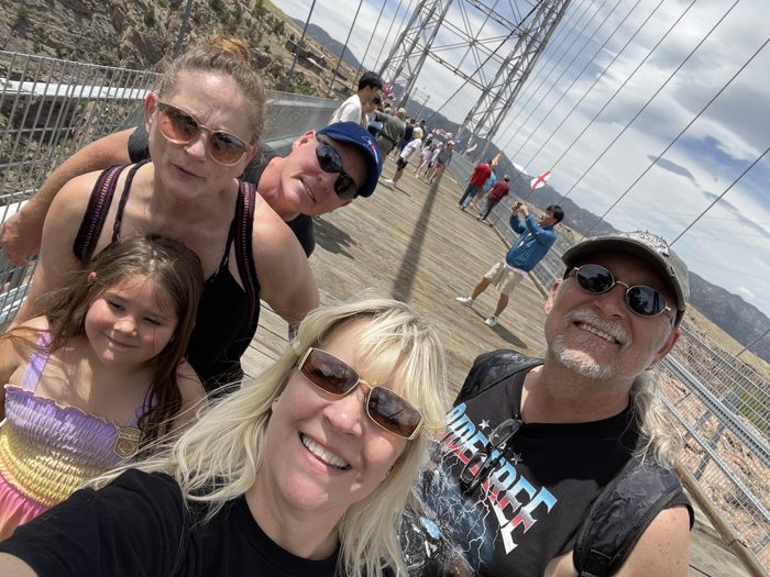 The whole family squeezing in for a sunny selfie out on the Royal Gorge Bridge.