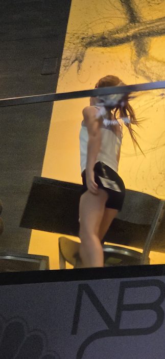 One of the kids caught mid-spin on the sports bar's upper deck, hair flying in the golden afternoon light.