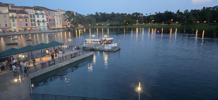 The dock lights up at dusk as guests wait for the next water taxi to pull in.