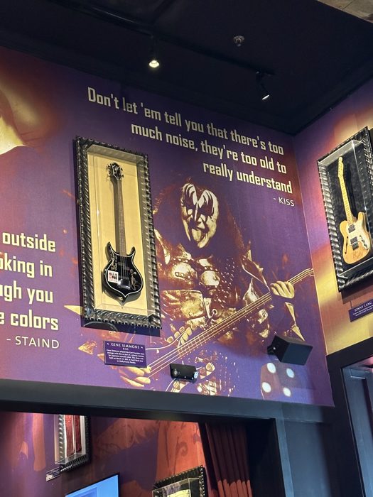 A glowing purple-lit memorabilia display inside the Hard Rock Cafe.