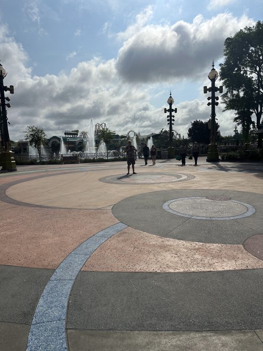 The kids cross the circular tiled plaza as we head toward the next land.