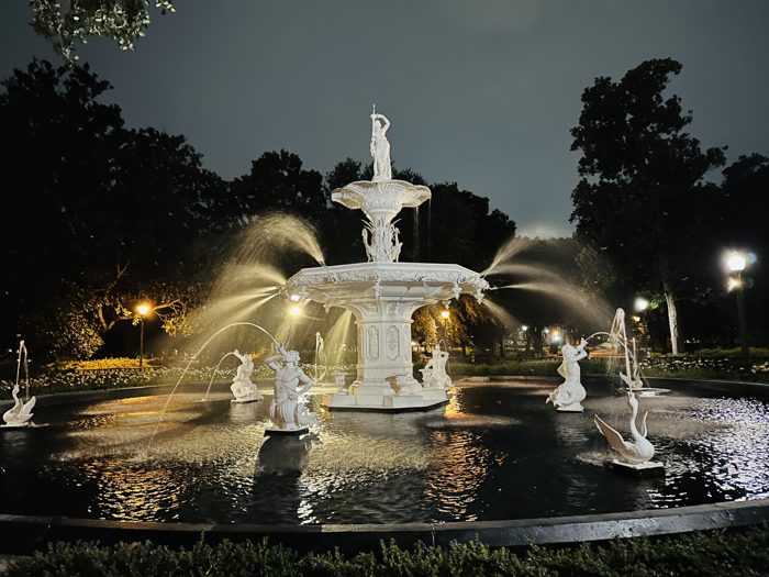 The iconic Forsyth Park fountain illuminated after dark.