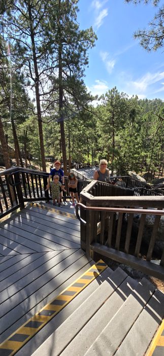 Walking the pine-shaded boardwalk of the Presidential Trail beneath the carving.