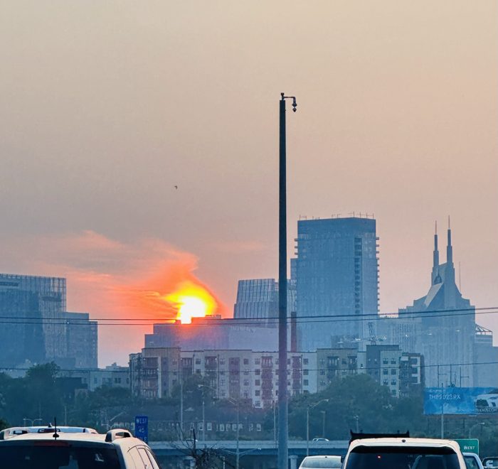 A fiery sunset glowing behind the Nashville skyline.