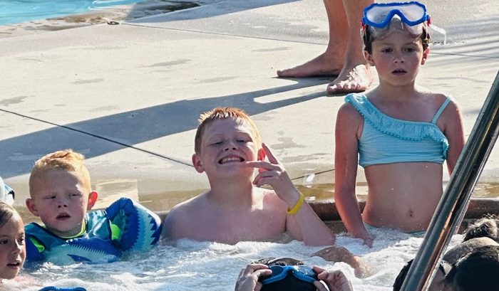 Snorkel masks on and grinning ear to ear in the Legoland water play area.