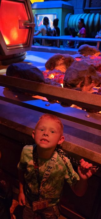 Same spooked expression, chain in hand, with the lava pit lit up behind him.