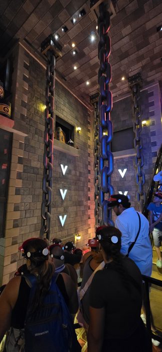 Waiting our turn beneath the massive hanging chains in the castle queue.