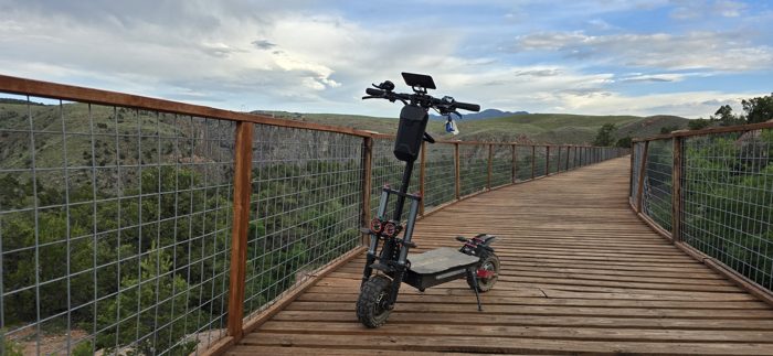 The scooter parked on a planked overlook deck above the gorge.