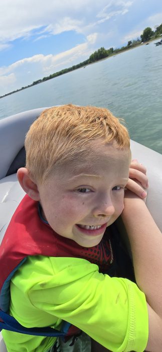All smiles in a life vest during the boat ride on Boyd Lake.