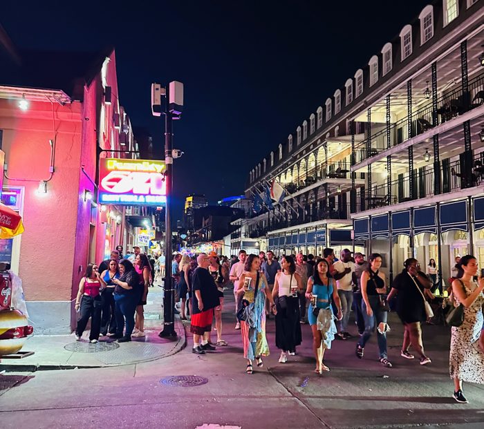 The neon-lit crowds pack Bourbon Street after dark.