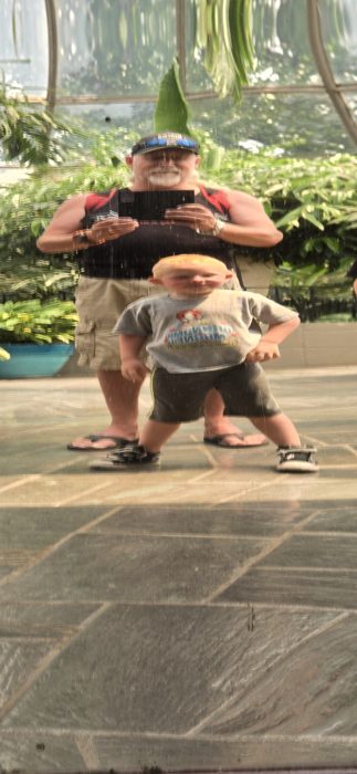 Family laughs through the funhouse sumo-wrestling photo op.