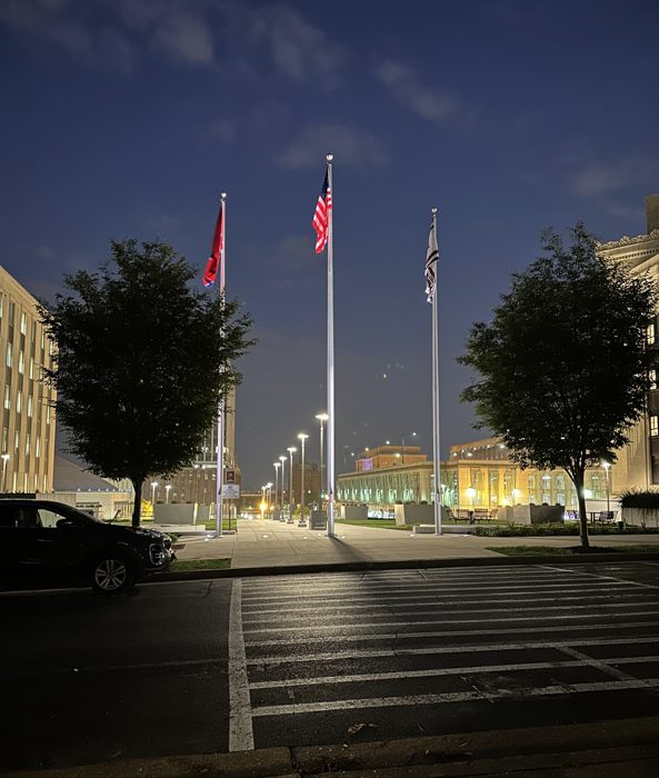 Flags fly at the Capitol grounds as dusk settles over downtown.