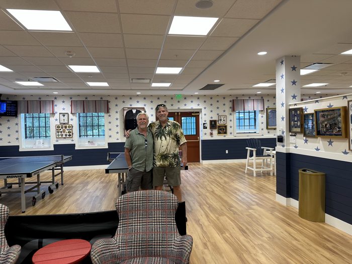 Another pose with an old friend among the ping pong tables and memorabilia wall in the clubhouse.