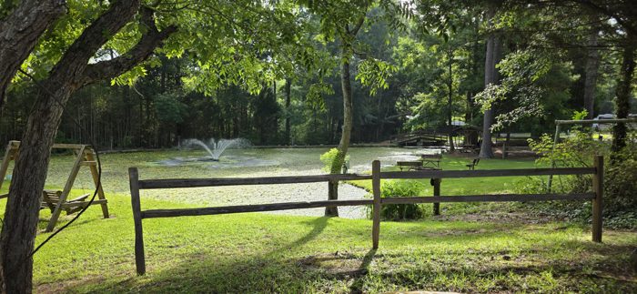 Morning quiet settles over the campground's lily-covered pond and its bubbling fountain.