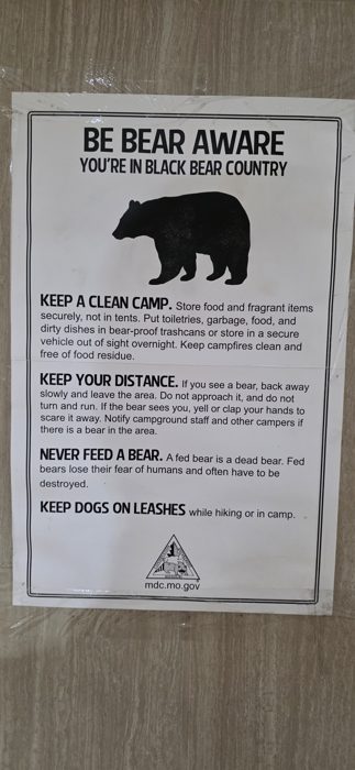 A "Be Bear Aware" notice posted at the campground reminds everyone to keep a clean camp in bear country.