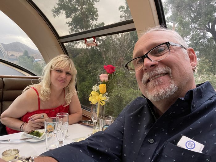 Toasting and smiling at our table aboard the dinner train.