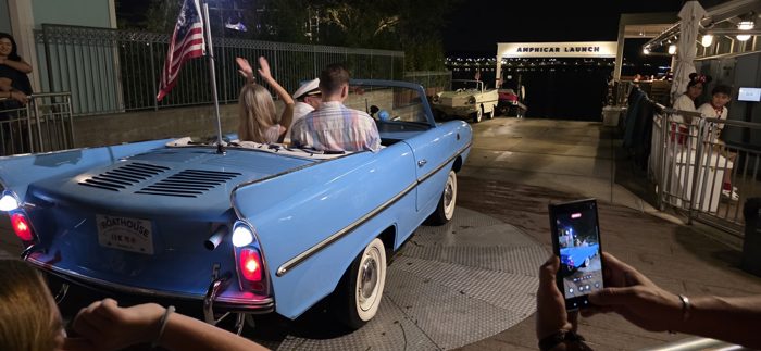 Climbing into a vintage powder-blue Amphicar for a nighttime launch at Disney Springs' Boathouse.