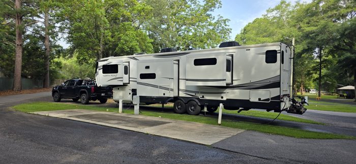 Our rig tucked into a shady site under tall oaks, hooked up and ready to roll for the day.