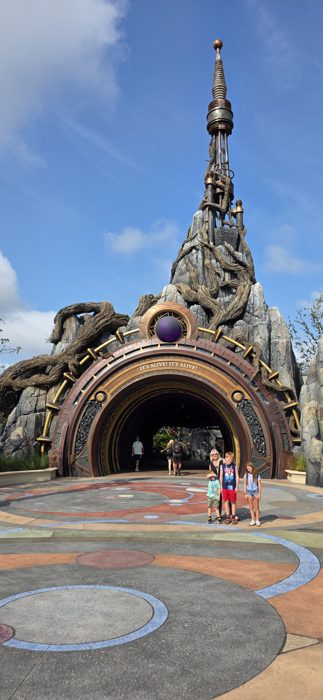 The family lines up for a photo as other visitors stream through the archway behind us.