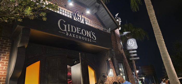 Another look up at the Gideon's Bakehouse facade, its hanging sign listing cookies, cakes, and curiosities.