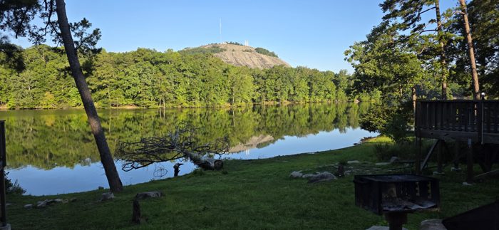 The view from our fire pit, Stone Mountain glowing gold above the still morning water.