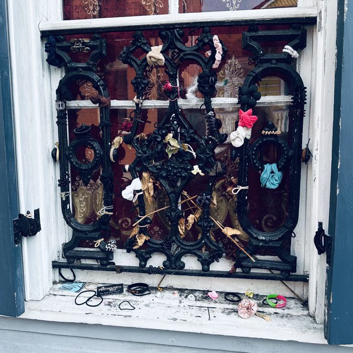 A voodoo shop window crammed with skulls, masks, and curios in the heart of the Quarter.
